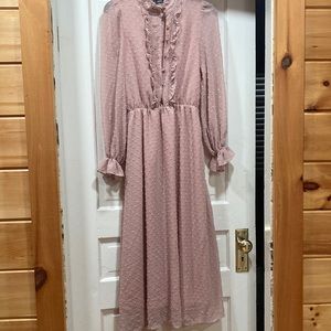Long sleeve pink dress with buttons.